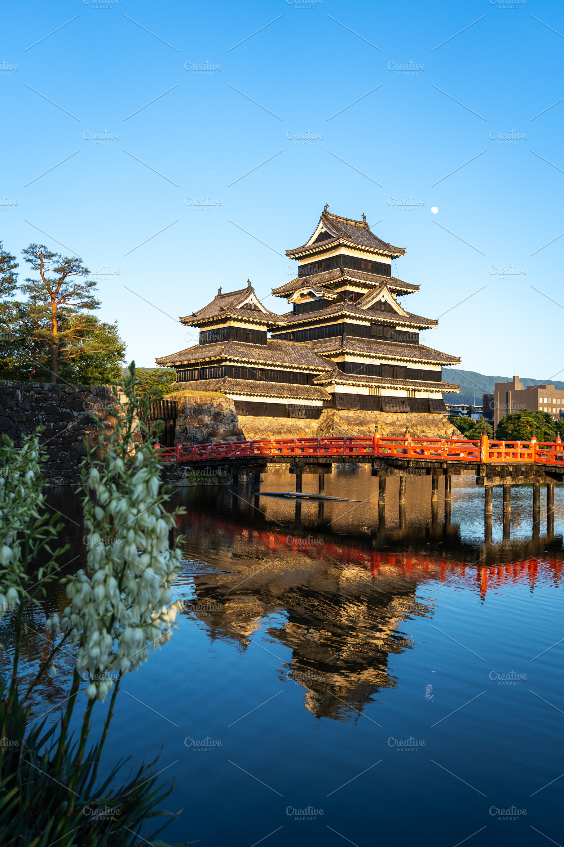 Matsumoto Castle and red bridge at sunset, Japan, an Architecture Photo by GoodGoods