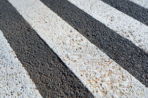 Textured asphalt surface with black and white stripes, an Abstract Photo by AlyaAnd