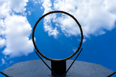 Upward view of a worn basketball hoop without a net against a vi, a Sports & Recreation Photo by Ales Munt