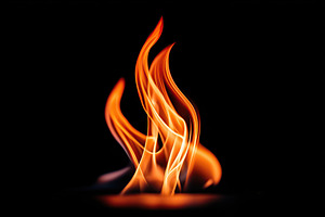 Flames dance elegantly in the dark showcasing vibrant orange and yellow hues, an Arts & Entertainment Photo by AlyaAnd