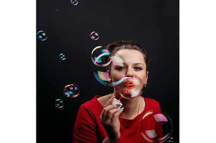 Beauty woman blowing soap bubbles., a Person Photo by Maksym Zaitsev