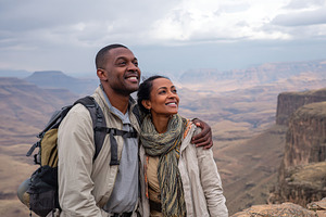 Couple enjoys breathtaking mountain view while hiking in nature at sunset in sc, a Photo by AlyaAnd