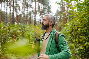 Handsome man watching wildlife with, a Sports & Recreation Photo by HalfPoint