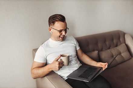 Smiling freelancer using laptop