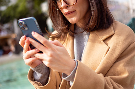 Woman in glasses using smartphone outdoor, a Person Photo by andreonegin market