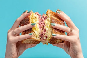 Hands hold sandwich with filling, a Photo by Beautiful things