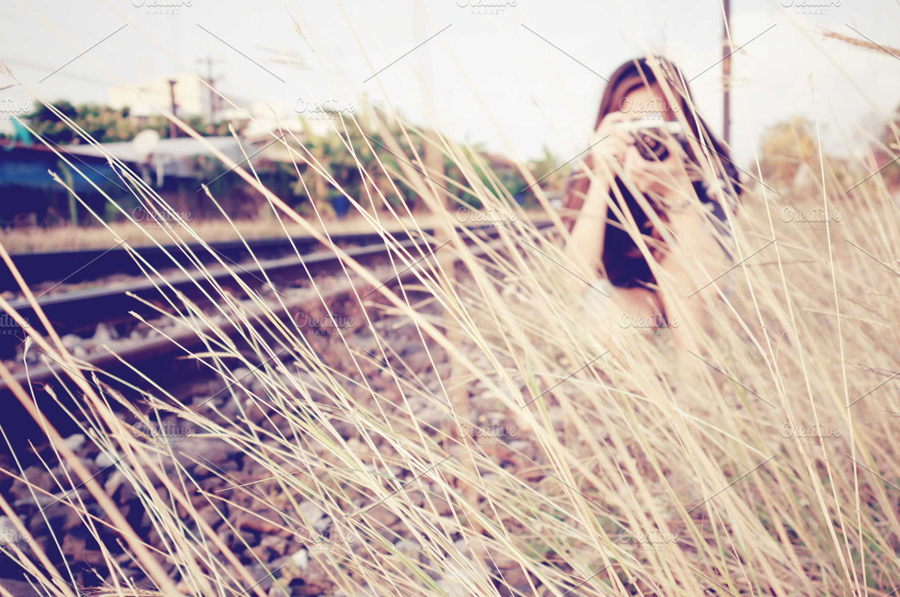 A woman taking photos at a railway featuring pretty, photographer, and