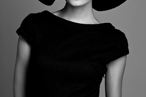 Woman retro fashion portrait featuring black, white, and hat