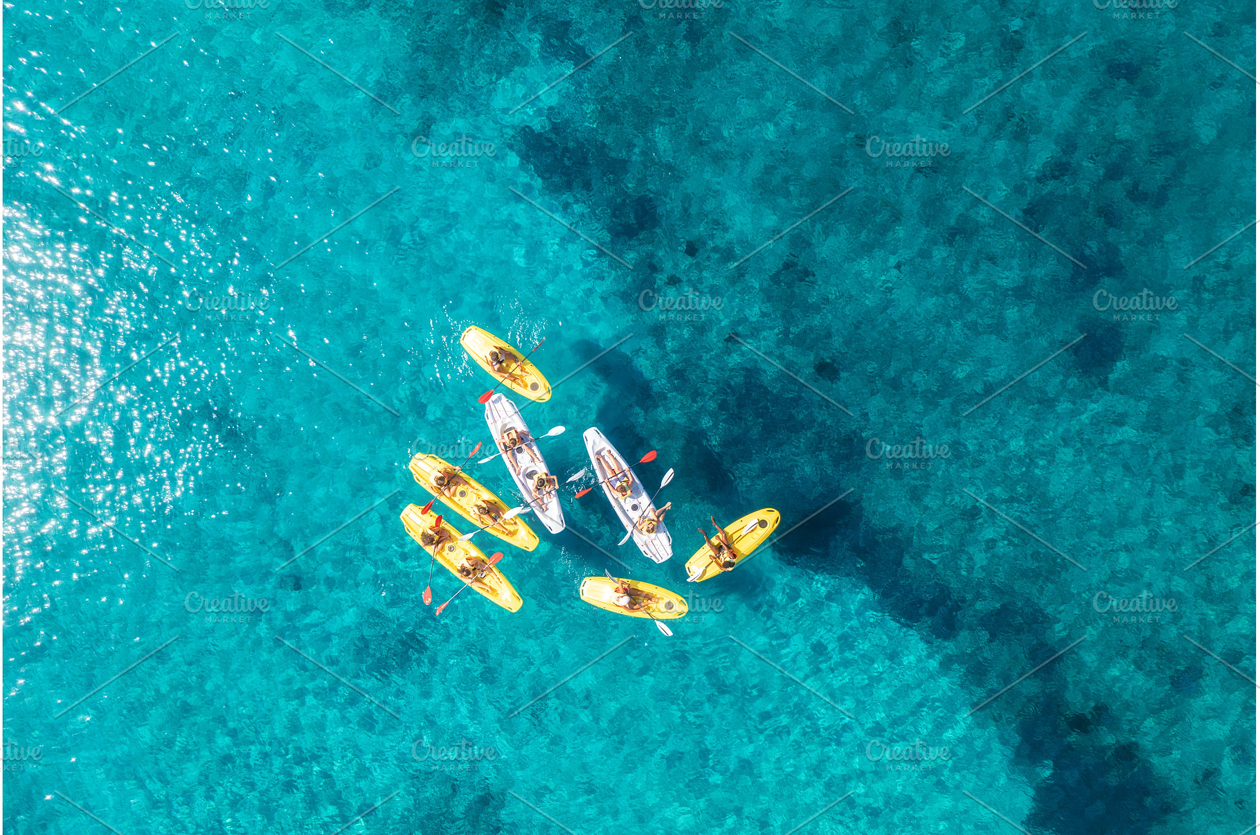 Aerial view of yellow kayaks in blue, a Nature Photo by den-belitsky