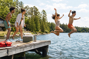 Group enjoying summer day jumping in, a Photo by Dvoevnore photos