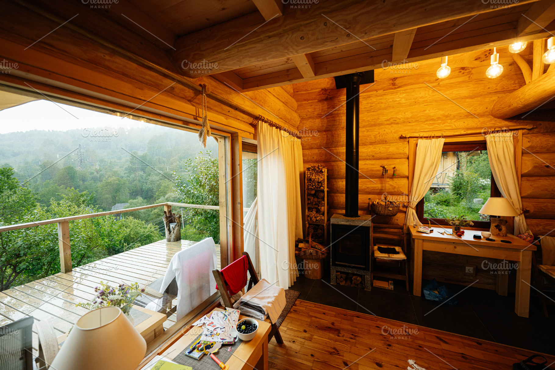 Cozy cabin interior with wooden decor overlooking lush green scenery, a Photo by AS photostudio