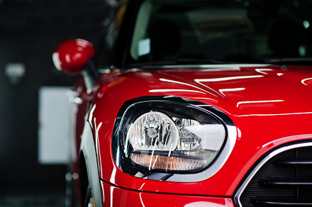 Headlights and hood of sport red car in garage., a Transportation Photo by AS photostudio