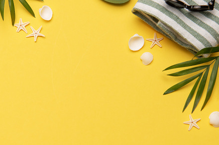 Summer holiday beach background with beach accessories and tropi