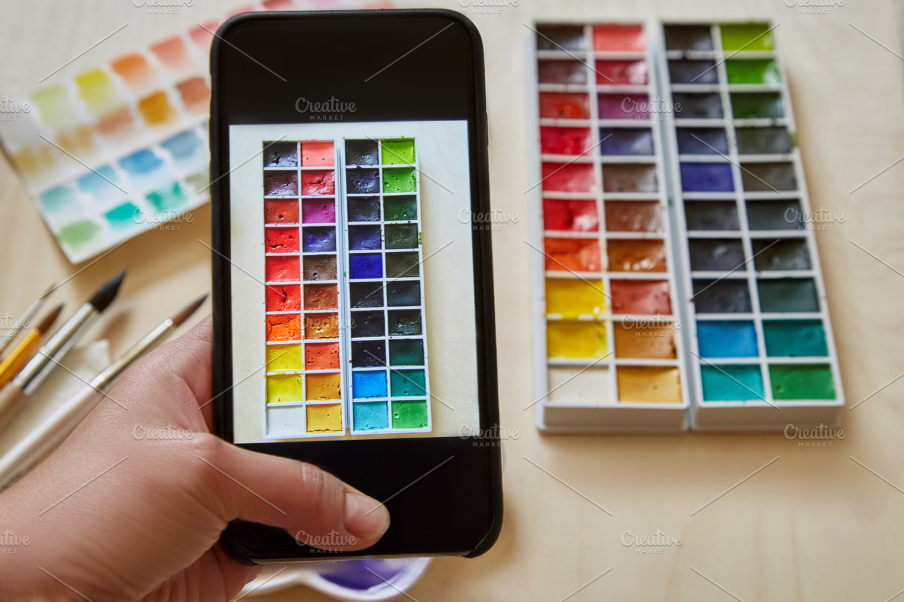 woman hand with smartphone - takes a picture of the box watercolors, an Arts & Entertainment Photo by ArtChamomile