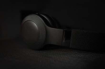 Black headphones in dark, a Technology Photo by Juicy Photography