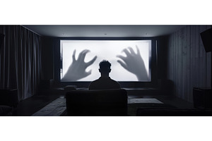 Man watching horror movie alone in, a Person Photo by piter.goskov