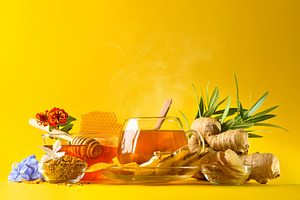 Glass cup with ginger and honey infusion yellow isolated backgro, a Photo by Davizro's Market