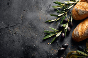 Fresh bread and olives on a table, a Photo by Beautiful things