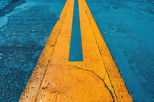 Bold yellow directional arrow on textured pavement, decision and, an Abstract Photo by José Manuel Gelpi