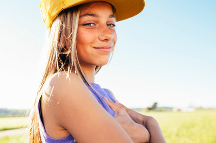 Outdoor portrait of a beautiful young blonde woman in a yellow cap and a bracke, a Person Photo by karrastock