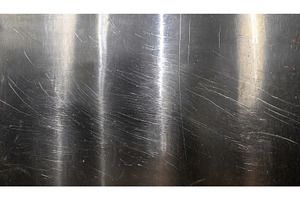 A close-up view of scratched metal, a Background Photo by Igor Tichonow