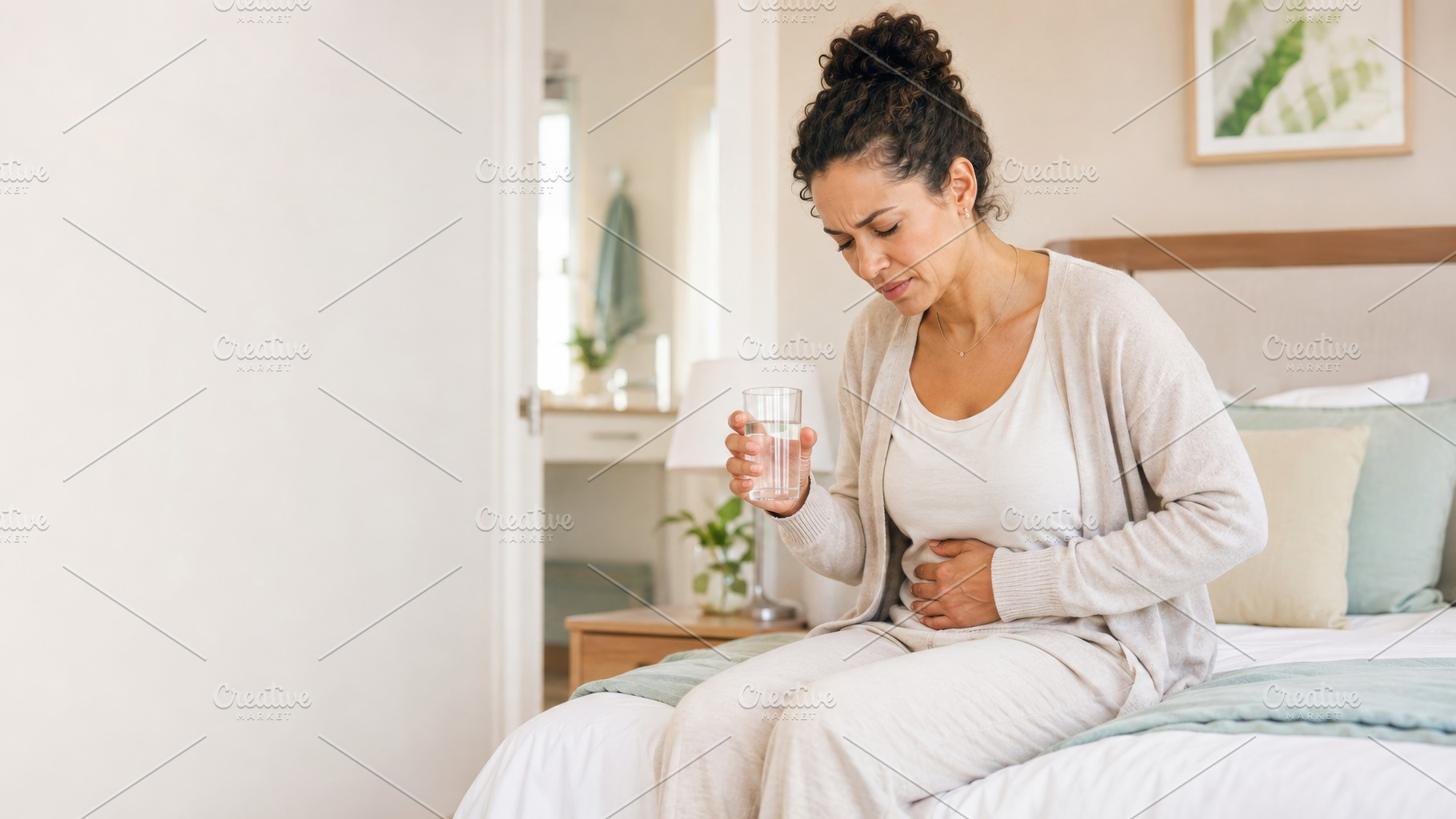 Woman experiencing abdominal pain at, a Photo by Dvoevnore photos