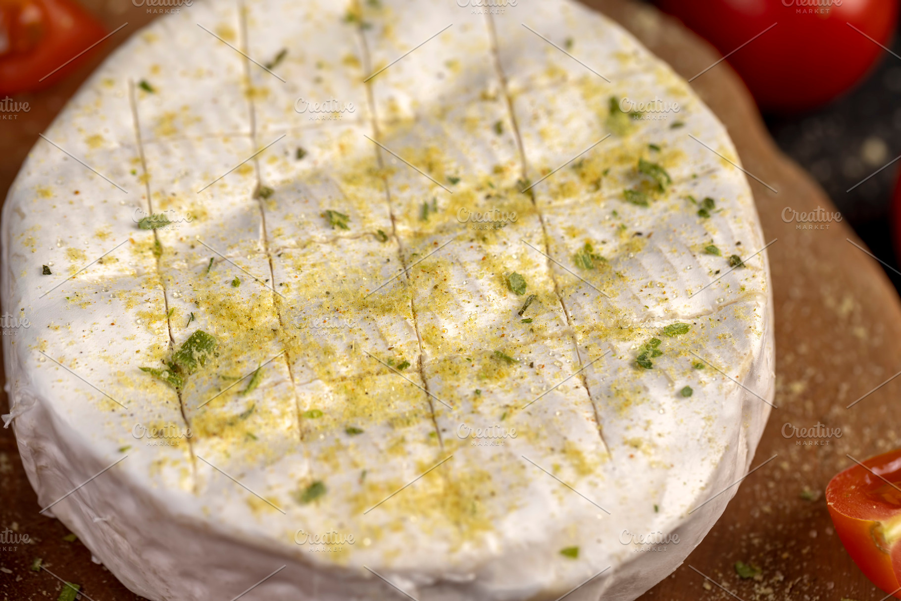white soft cheese in salt and spices and small red round tomatoes on the table, a Photo by rsoollAI