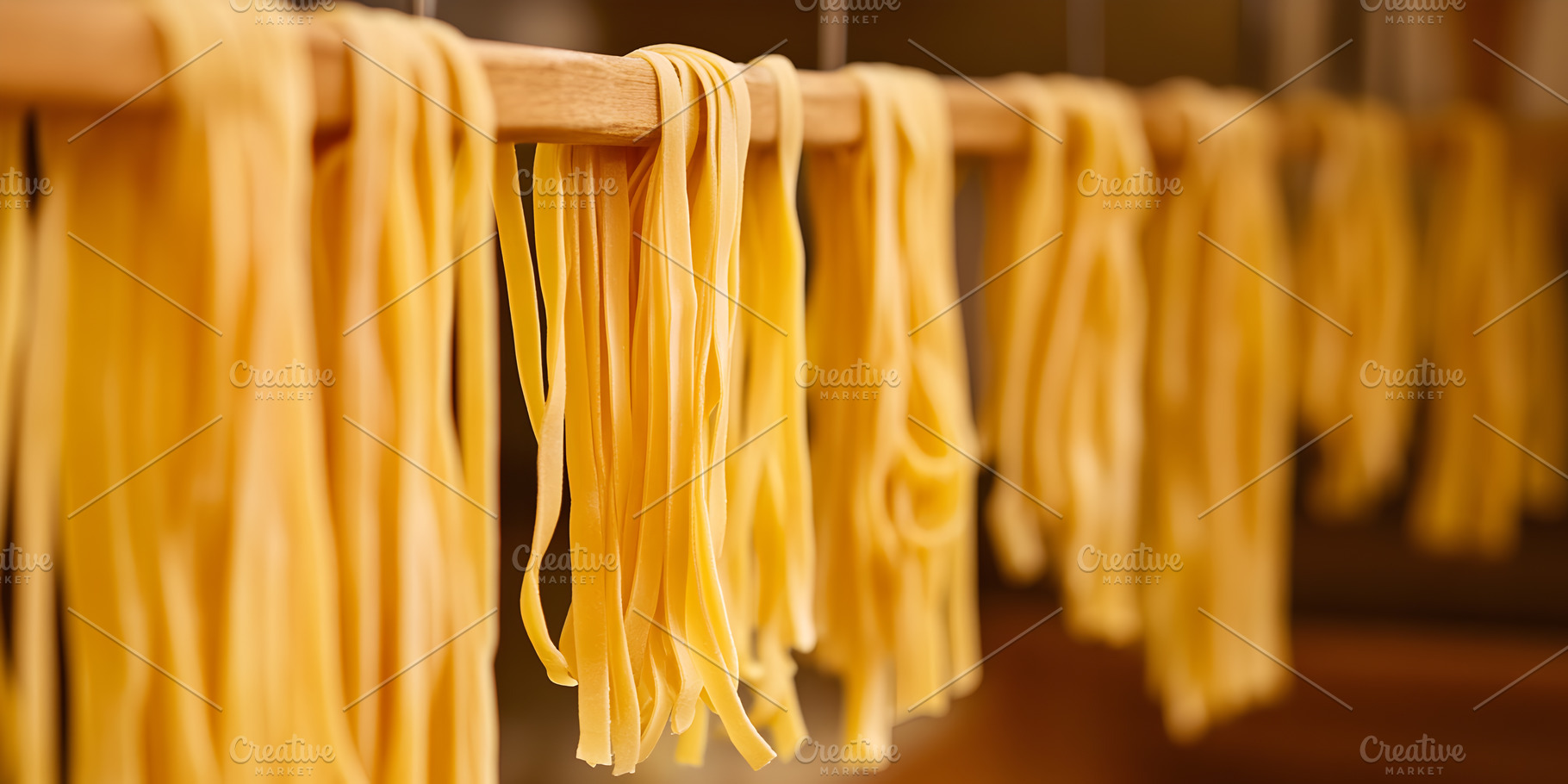 Fresh tagliatelle pasta hanging to d, a Food & Drink Photo by Photostock