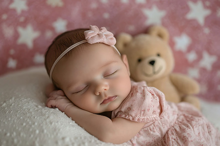Newborn child in co-sleeper crib sleeping with her bear toy, a Person Photo by AlyaAnd