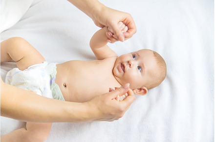 Mother massage baby on the bed, a Person Photo by yanadjana