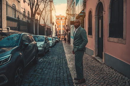 Stylish man amidst urban scenery, a Person Photo by SkyNext