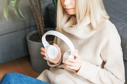Young caucasian woman relaxes at home with music, a Person Photo by Olena Rudo