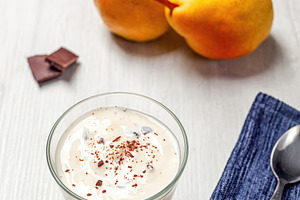 Yogurt with grated chocolate and pears on white wooden table, a Food & Drink Photo by Antonio Gravante Market