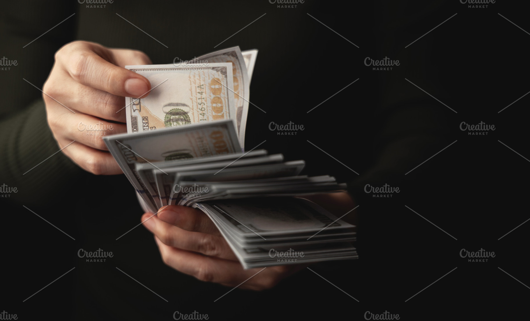 Hands counting US dollar banknote, symbolizing finance, payment,, a Photo by salmon.black
