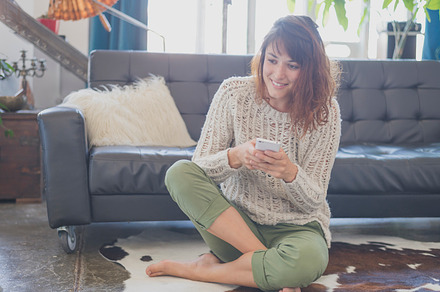 Woman using her smartphone featuring adult, adults only, and beautiful people, a Person Photo by 2Design