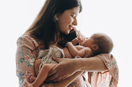 Happy Mothers day! Stylish Mother holding and hugging cute newbo
