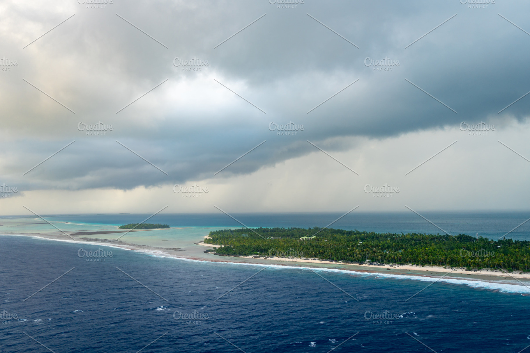 Aerial view of Tikehau atoll, French Polynesia, with cloudy sky, a Nature Photo by GoodGoods