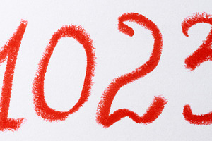 A number written in red chalk or pastel on a white background, w, an Abstract Photo by ndanko