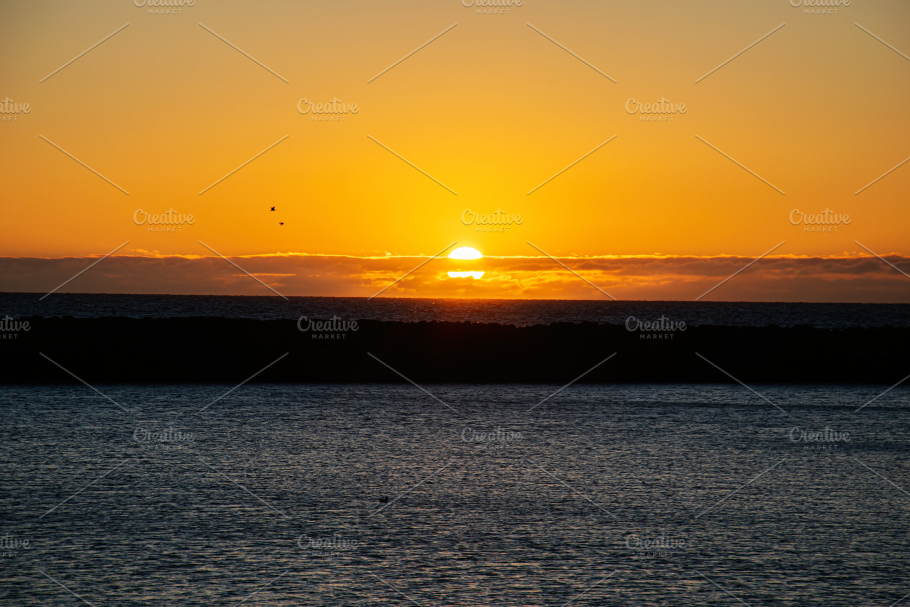 Sunset over the ocean with golden hues and black silhouette, Iceland view, a Nature Photo by AS photostudio