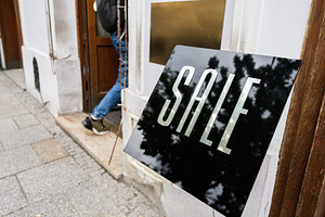 Sale Sign Displayed on a Sidewalk Near Store Entrance, a Photo by AS photostudio