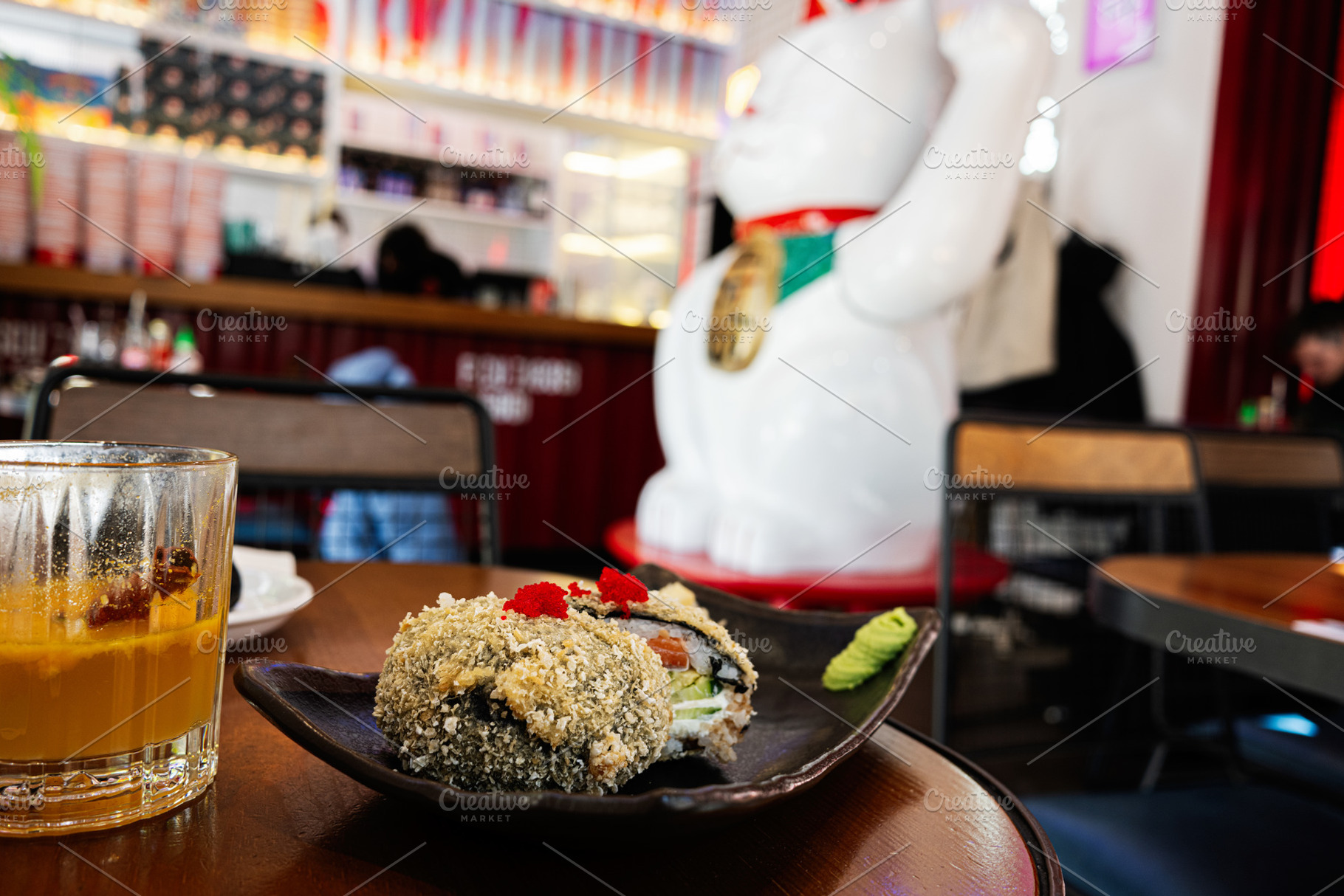 Closeup of sushi and drink on table in vibrant restaurant interior setting, a Photo by AS photostudio