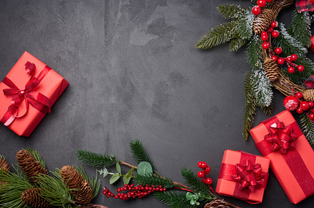 Christmas wreaths, fir branches and gifts on a black background., a Holiday Photo by ndanko