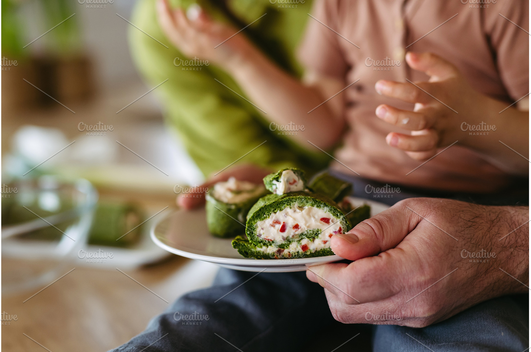 Close up of little boy eating green, a Food & Drink Photo by HalfPoint