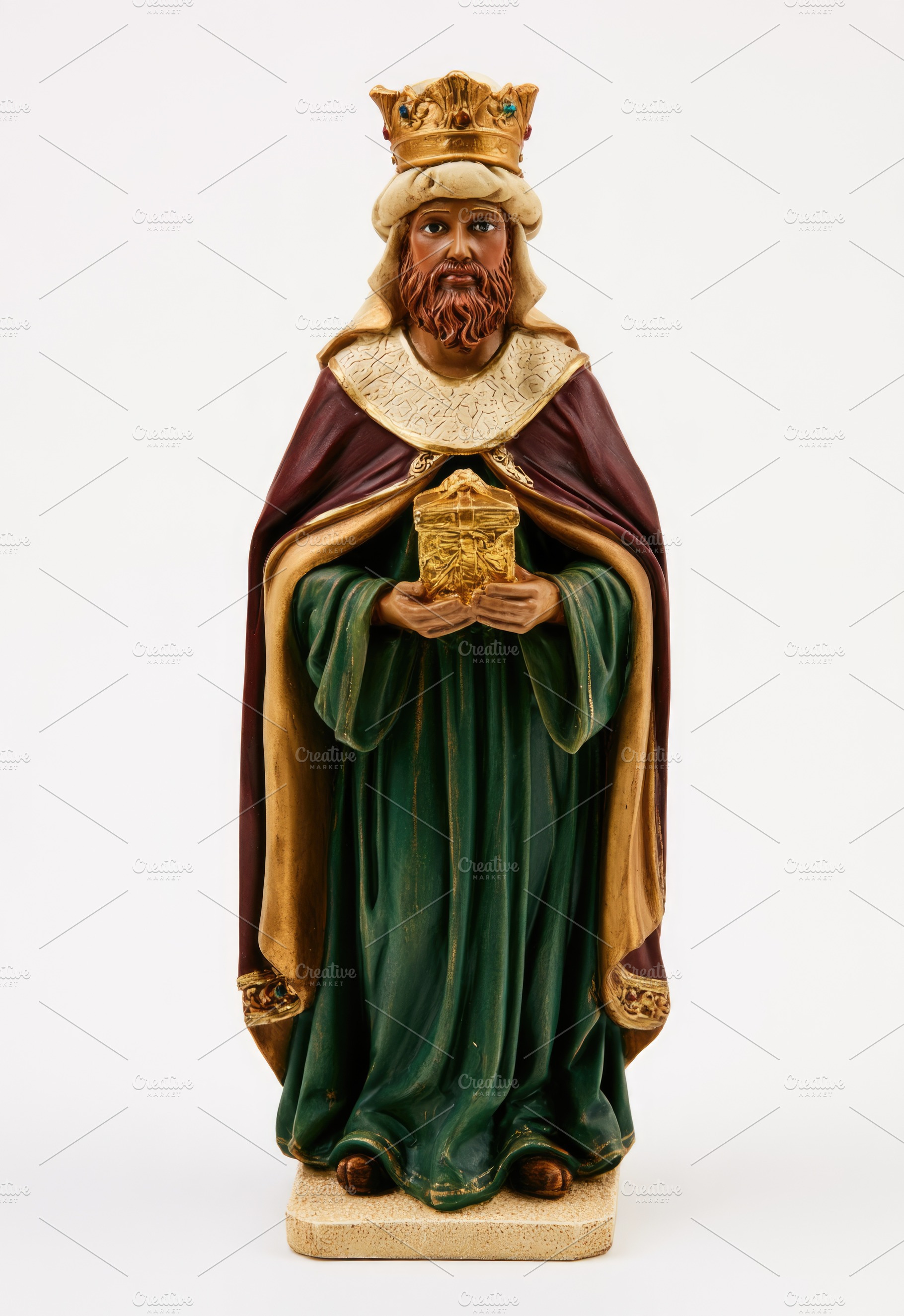 Gaspar Three Wise Men figurine holding golden gift isolated on w, a Food & Drink Photo by José Manuel Gelpi