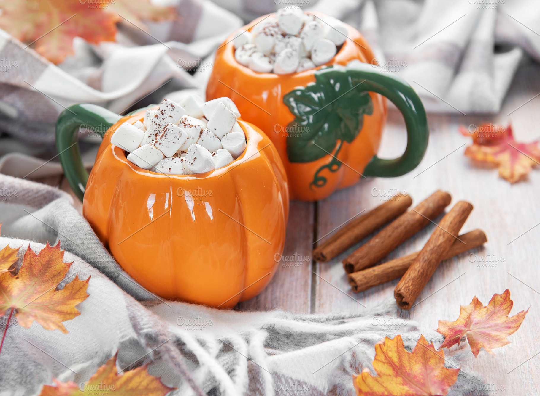 Pumpkin mugs filled with hot chocolate for autumn comfort, a Food & Drink Photo by Olena Rudo