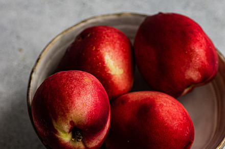 Ripe nectarine fruits in the bowl, a Food & Drink Photo by Anna Bogush