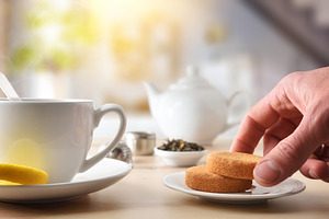 Person's hand taking biscuit from a ceramic plate for breakfast, a Food & Drink Photo by Davizro's Market