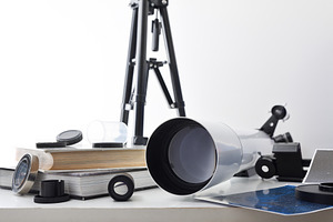 View of a telescope lens on white table with tools, a School & Education Photo by Davizro's Market