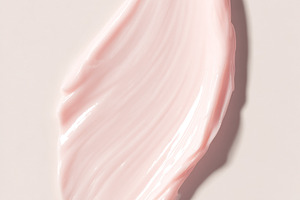 Creamy pink cosmetic product smear on a light background, highli, a Photo by Studio ANNA