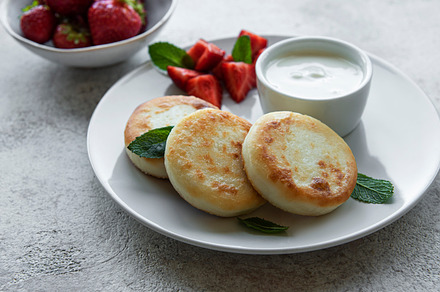 Cottage cheese pancakes, ricotta fritters on ceramic plate with, a Food & Drink Photo by Olena Rudo